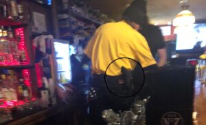Read more about the article West Virginia bartender pouring beer, wearing open-carry sidearm